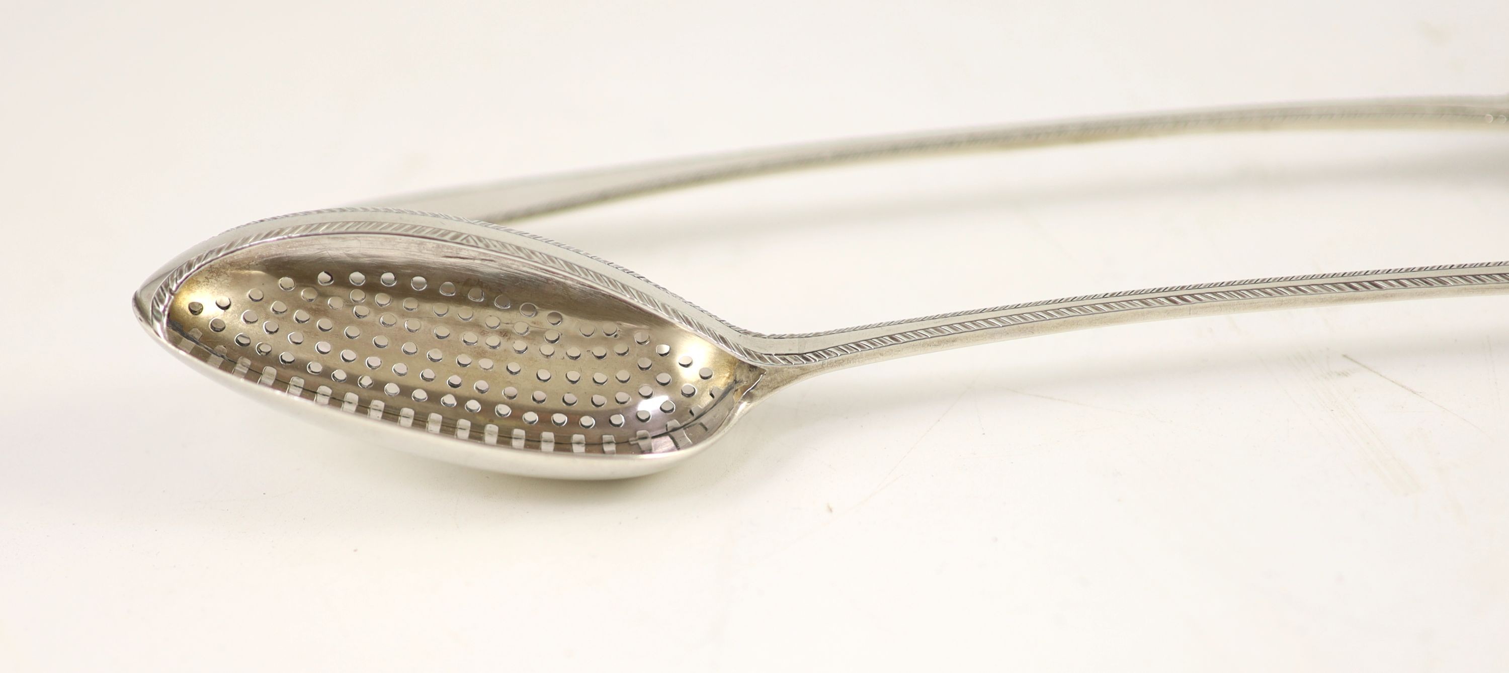 A pair of George III silver feather edge Old English pattern straining spoons, marks pinched